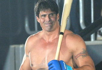 YOKOHAMA, JAPAN - MAY 26:  Former Oakland Athletics slugger Jose Canseco (L) walks to the ring with holding a bat prior to the match with Choi Hong-man at first Round of Super Hulk Tournament during Dream.9 at Yokohama Arena on May 26, 2009 in Yokohama, Kanagawa, Japan. Canseco lost at 1 minute 17 seconds in the first round.  (Photo by Hiroki Watanabe/Getty Images)