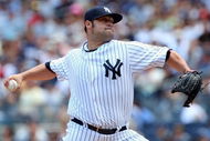 NEW YORK - JULY 19:  Joba Chamberlain #62 of the New York Yankees pitches against the Detroit Tigers on July 19, 2009 at Yankee Stadium in the Bronx borough of New York City.  (Photo by Jim McIsaac/Getty Images)