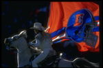 15 Dec 1996:  A Denver Broncos fan rides the mascot and flies a flag during a game against the Oakland Raiders at Mile High Stadium in Denver, Colorado.  The Broncos won the game, 24-19. Mandatory Credit: Brian Bahr  /Allsport