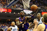 ORLANDO, FL - JUNE 14:  Lamar Odom #7 of the Los Angeles Lakers goes up for a shot between Rashard Lewis #9 and Dwight Howard #12 of the Orlando Magic in the second quarter of Game Five of the 2009 NBA Finals on June 14, 2009 at Amway Arena in Orlando, Florida.  NOTE TO USER:  User expressly acknowledges and agrees that, by downloading and or using this photograph, User is consenting to the terms and conditions of the Getty Images License Agreement.  (Photo by Ronald Martinez/Getty Images)