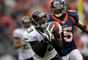 DENVER - OCTOBER 12:  Safety Gerald Sensabaugh #43 of the Jacksonville Jaguars makes an interception on a pass intended for wide receiver Brandon Marshall #15 of the Denver Broncos from Jay Cutler during NFL action on October 12, 2008 at Invesco Field at Mile High in Denver, Colorado.  (Photo by Doug Pensinger/Getty Images)