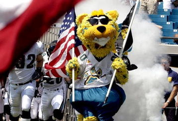 Jacksonville Jaguars mascot leads the team to the field amid flying flags.  The Buffalo  Bills defeated the Jaguars 38 - 17  (Photo by Al Messerschmidt/Getty Images)