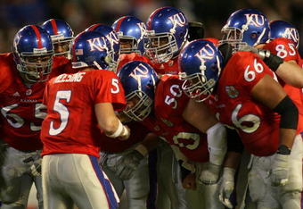 MIAMI - JANUARY 03:  Quarterback Todd Reesing #5 of the Kansas Jayhawks huddles with his team in the first quarter against the Virginia Tech Hokies during the FedEx Orange Bowl at Dolphin Stadium on January 3, 2008 in Miami, Florida.  (Photo by Marc Serota/Getty Images)