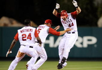 ANAHEIM, CA - JULY 23: Mike Napoli #44 of the Los Angeles Angels of Anaheim is chased by his teammates Jeff Mathis #5 and Gary Matthews Jr. #24 after hitting the game winning double to score Chone Figgins against the Minnesota Twins during the inning of the baseball game on July 23, 2009 in Anaheim, California.  Angels came from behind to defeat the Twins, 5-4. (Photo by Kevork Djansezian/Getty Images)