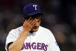 ARLINGTON, TX - SEPTEMBER 28:  Chan Ho Park #61 of the Texas Rangers wipes his forehead while leaving the game after giving up two runs against the Anaheim Angels in the 5th inning September 28, 2004 at Ameriquest Field in Arlington in Arlington, Texas.  (Photo by Ronald Martinez/Getty Images)