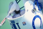 Peyton Manning #18 of the Indianapolis Colts holds his helmet during a pre-season game against the St. Louis Rams at the Memorial Stadium of Illinois in Champaign, Illinois.