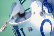 Peyton Manning #18 of the Indianapolis Colts holds his helmet during a pre-season game against the St. Louis Rams at the Memorial Stadium of Illinois in Champaign, Illinois.