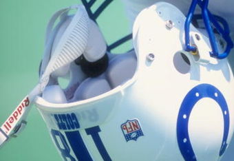 Peyton Manning #18 of the Indianapolis Colts holds his helmet during a pre-season game against the St. Louis Rams at the Memorial Stadium of Illinois in Champaign, Illinois.
