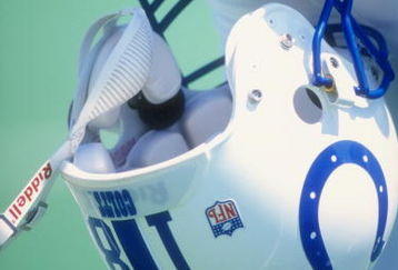 Peyton Manning #18 of the Indianapolis Colts holds his helmet during a pre-season game against the St. Louis Rams at the Memorial Stadium of Illinois in Champaign, Illinois.