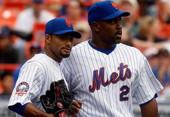 NEW YORK - APRIL 12:  Johan Santana #57 of the New York Mets talks with teammate Carlos Delgado #21 against the Milwaukee Brewers on April 12, 2008 at Shea Stadium in the Flushing neighborhood of the Queens borough of New York City.  (Photo by Nick Laham/Getty Images)