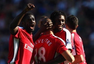 WIGAN, ENGLAND - APRIL 11:  Mikael Silvestre of Arsenal is congratulated by Kolo Toure and Emmanuel Adebayor after scoring the second goal during the Barclays Premier League match between Wigan Athletic and Arsenal at The JJB Stadium on April 11, 2009 in Wigan, England.  (Photo by Laurence Griffiths/Getty Images)