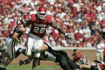 NORMAN, OK - OCTOBER 2:  Running back Adrian Peterson #28 of the Oklahoma Sooners tries to run upfield against the Texas Tech Red Raiders on October 2, 2004 at Memorial Stadium in Norman, Oklahoma.  The Sooners defeated the Red Raiders  28-13.  (Photo by Brian Bahr/Getty Images)