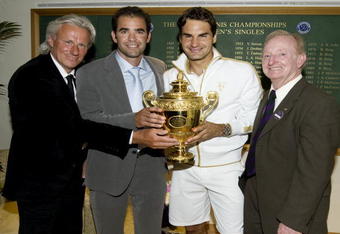 WIMBLEDON, ENGLAND - JULY 05:  Roger Federer of Switzerland (2R) celebrates with the trophy alongside Bjorn Borg (L), Pete Sampras (2L) and Rod Laver (R)  after the men's singles final match against Andy Roddick of USA on Day Thirteen of the Wimbledon Lawn Tennis Championships at the All England Lawn Tennis and Croquet Club on July 5, 2009 in London, England. Federer won 5-7, 7-6, 7-6, 3-6, 16-14, to claim his 15th Grand Slam title.  (Photo by AELTC/Pool/Getty Images)