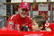 TOKYO - OCTOBER 8:  Michael Schumacher of Germany and Ferrari poses on Stage with a local child during an appearance at the Showa Shell headquarters on October 8, 2003 in Tokyo, Japan. (Photo by Mark Thompson/Getty Images).
