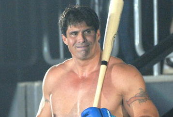 YOKOHAMA, JAPAN - MAY 26:  Former Oakland Athletics slugger Jose Canseco (L) walks to the ring with holding a bat prior to the match with Choi Hong-man at first Round of Super Hulk Tournament during Dream.9 at Yokohama Arena on May 26, 2009 in Yokohama, Kanagawa, Japan. Canseco lost at 1 minute 17 seconds in the first round.  (Photo by Hiroki Watanabe/Getty Images)