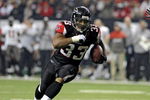 ATLANTA - DECEMBER 14: Running back Michael Turner #33 of the Atlanta Falcons rushes upfield against the Tampa Bay Buccaneers  at the Georgia Dome on December 14, 2008 in Atlanta, Georgia.  (Photo by Al Messerschmidt/Getty Images) 