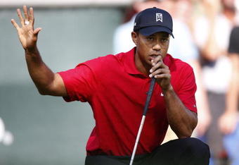 GRAND BLANC, MI - AUGUST 02:  Tiger Woods asks the fans to quiet down on the 17th green during the final round of the Buick Open at Warwick Hills Golf and Country Club on August 2, 2009 in Grand Blanc, Michigan. Woods won the tournament with a final score of 20 under par.  (Photo by Gregory Shamus/Getty Images)