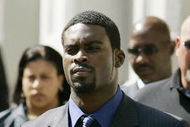 RICHMOND, VA - JULY 26: Escorted by U.S. marshals, Atlanta Falcons quarterback Michael Vick leaves the federal courthouse following his arraignment July 26, 2007 in Richmond, Virginia. Vick and three associates were indicted earlier this month on charges related to their alleged role in an interstate dogfighting ring. (Photo by Haraz N. Ghanbari-Pool/Getty Images)