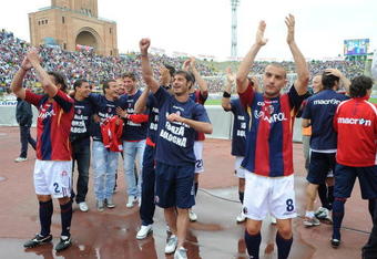 BOLOGNA, ITALY - MAY 31:  Nicola Mingazzini #8, Davide Marchini #2 and Bologna FC players celebrate for remaining in A category after winning 3:1 their Serie A match against Calcio Catania at the Stadio Renato Dall'Ara on May 31, 2009 in Bologna, Italy.  (Photo by New Press/Getty Images)