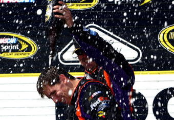 LONG POND, PA - AUGUST 03:  Denny Hamlin (L), driver of the #11 FedEx Express Toyota, celebrates with a crew member in victory lane after winning the NASCAR Sprint Cup Series Sunoco Red Cross Pennsylvania 500 at the Pocono Raceway on August 3, 2009 in Long Pond, Pennsylvania.  (Photo by Chris McGrath/Getty Images)