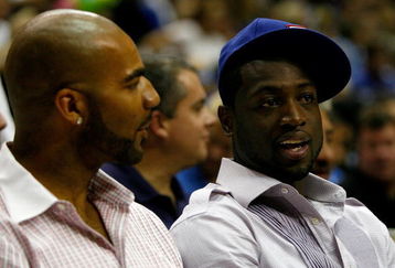 ORLANDO, FL - JUNE 11:  US Olympic teammates Carlos Boozer of the Utah Jazz and Dwyane Wade of the Miami Heat sit together at Game Four of the 2009 NBA Finals between the Los Angeles Lakers and the Orlando Magic on June 11, 2009 at Amway Arena in Orlando, Florida.  NOTE TO USER:  User expressly acknowledges and agrees that, by downloading and or using this photograph, User is consenting to the terms and conditions of the Getty Images License Agreement.  (Photo by Chris Graythen/Getty Images)