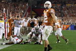 GLENDALE, AZ - JANUARY 05:  Quarterback Colt McCoy #12 of the Texas Longhorns scores on a 14 yard touchdown rush against the Ohio State Buckeyes during the third quarter of the Tostitos Fiesta Bowl Game on January 5, 2009 at University of Phoenix Stadium in Glendale, Arizona.  (Photo by Jed Jacobsohn/Getty Images)