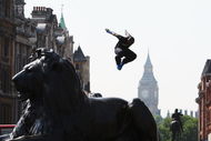 LONDON, ENGLAND - JULY 02:  A Free Runner jumps from a Lion statue during the media launch of the Barclaycard World Freerun Championships at Trafalgar Square on 2 July, 2009 in London, England.  The 2009 Barclaycard World Freerun Championships will be held in Trafalgar Square on 15th August.  (Photo by Ryan Pierse/Getty Images for Barclaycard)