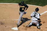 CHICAGO - JULY 06: Daric Barton #10 of the Oakland Athletics scores a run in the 7th inning as the ball gets away from A.J. Pierzynski #12 of the Chicago White Sox on July 6, 2008 at U.S. Cellular Field in Chicago, Illinois. The White Sox defeated the Athletics 4-3. (Photo by Jonathan Daniel/Getty Images)