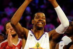 PHOENIX - FEBRUARY 13:  Kevin Durant #35 of the Sophomore team holds up the MVP trophy after the Sophomores won the T-Mobile Rookie Challenge & Youth Jam part of 2009 NBA All-Star Weekend at US Airways Center on February 13, 2009 in Phoenix, Arizona.  NOTE TO USER: User expressly acknowledges and agrees that, by downloading and or using this photograph, User is consenting to the terms and conditions of the Getty Images License Agreement.  (Photo by Ronald Martinez/Getty Images)