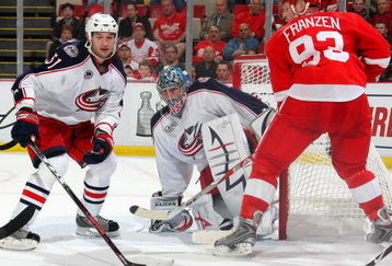 DETROIT - APRIL 16:  Steve Mason #1 of the Columbus Blue Jackets makes a save as teammate Fedor Tyutin #51 keeps an eye on both the puck and Johan Franzen #93 of the Detroit Red Wings during Game One of the Western Conference Quarterfinals of the 2009 Stanley Cup Playoffs on April 16, 2009 at Joe Louis Arena in Detroit, Michigan.  (Photo By Dave Sandford/Getty Images)