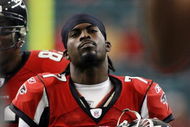 ATLANTA - DECEMBER 24:   Quarterback Michael Vick #7 of the Atlanta Falcons walks off against the Carolina Panthers December 24, 2006 at The Georgia Dome  in Atlanta,Georgia  (Photo by Marc Serota/Getty Images)