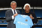 MANCHESTER, ENGLAND - JULY 14:  Mark Hughes, manager of Manchester City, poses with Carlos Tevez after he signed for Manchester City at City of Manchester Stadium on July 14, 2009 in Manchester, England.  (Photo by Matthew Lewis/Getty Images)
