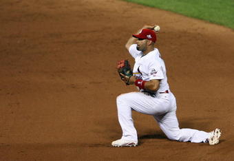 ST. LOUIS, MO - JULY 14:  National League All-Star Albert Pujols of the St. Louis Cardinals tosses the ball to first during the 2009 MLB All-Star Game at Busch Stadium on July 14, 2009 in St Louis, Missouri. (Photo by Elsa/Getty Images)