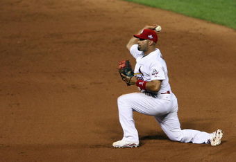 ST. LOUIS, MO - JULY 14:  National League All-Star Albert Pujols of the St. Louis Cardinals tosses the ball to first during the 2009 MLB All-Star Game at Busch Stadium on July 14, 2009 in St Louis, Missouri. (Photo by Elsa/Getty Images)