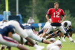 FOXBORO, MA - JULY 31:  Tom Brady #12 of the New England Patriots stretches during training camp on July 31, 2009 at Gillette Stadium in Foxboro, Massachusetts.  (Photo by Elsa/Getty Images)