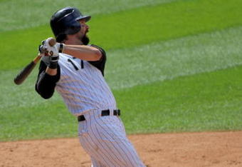 DENVER - JULY 22:  First baseman Todd Helton #17 of  the Colorado Rockies follows through on his game winning solo home run off of pitcher Scott Schoeneweis #60 of the Arizona Diamondbacks in the eighth inning during MLB action at Coors Field on July 22, 2009 in Denver, Colorado. The Rockies defeated the Diamondbacks 4-3.  (Photo by Doug Pensinger/Getty Images)
