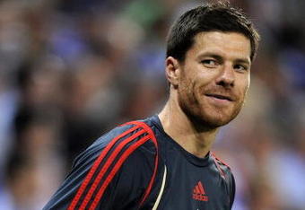 BARCELONA, SPAIN - AUGUST 02:  Xabi Alonso of Liverpool smiles during his warm up reacting to shouts from fans regarding his possible move to Real Madrid during the pre-season friendly match between Espanyol and Liverpool at the Nuevo Estadio de Cornella-El Prat on August 2, 2009 in Barcelona, Spain. Espanyol won the match 3-0.  (Photo by Jasper Juinen/Getty Images)