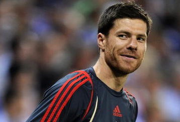 BARCELONA, SPAIN - AUGUST 02:  Xabi Alonso of Liverpool smiles during his warm up reacting to shouts from fans regarding his possible move to Real Madrid during the pre-season friendly match between Espanyol and Liverpool at the Nuevo Estadio de Cornella-El Prat on August 2, 2009 in Barcelona, Spain. Espanyol won the match 3-0.  (Photo by Jasper Juinen/Getty Images)