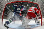 VANCOUVER, CANADA - MARCH 17:   ex Burrows #14  of the Vancouver Canucks runs into the net behind goaltender Dominik Hasek #39 of the Detroit Red Wings during their NHL game at General Motors Place on March 17, 2007 in Vancouver, Canada.   (Photo by Jeff Vinnick/Getty Images)
