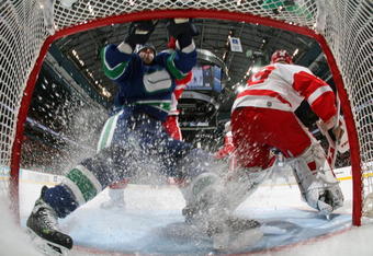 VANCOUVER, CANADA - MARCH 17:   ex Burrows #14  of the Vancouver Canucks runs into the net behind goaltender Dominik Hasek #39 of the Detroit Red Wings during their NHL game at General Motors Place on March 17, 2007 in Vancouver, Canada.   (Photo by Jeff Vinnick/Getty Images)
