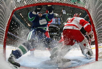 VANCOUVER, CANADA - MARCH 17:   ex Burrows #14  of the Vancouver Canucks runs into the net behind goaltender Dominik Hasek #39 of the Detroit Red Wings during their NHL game at General Motors Place on March 17, 2007 in Vancouver, Canada.   (Photo by Jeff Vinnick/Getty Images)
