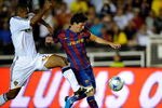 PASADENA, CA - AUGUST 01:   Lionel Messi #10 of FC Barcelona is pressured by Tony Sanneh #22 of the Los Angeles Galaxy during the first half of the friendly soccer match at the Rose Bowl on August 1, 2009 in Pasadena, California.  (Photo by Kevork Djansezian/Getty Images)