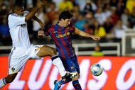 PASADENA, CA - AUGUST 01:   Lionel Messi #10 of FC Barcelona is pressured by Tony Sanneh #22 of the Los Angeles Galaxy during the first half of the friendly soccer match at the Rose Bowl on August 1, 2009 in Pasadena, California.  (Photo by Kevork Djansezian/Getty Images)