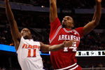 TAMPA, FL - MARCH 12:  Erving Walker #11 of the Florida Gators makes a shot over Andre Clark #44 of the Arkansas Razorbacks during the first round of the SEC Men's Basketball Tournament on March 12, 2009 at The St. Pete Times Forum in Tampa, Florida.  (Photo by Chris Graythen/Getty Images)