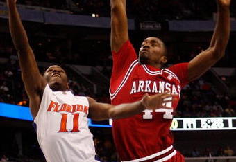 TAMPA, FL - MARCH 12:  Erving Walker #11 of the Florida Gators makes a shot over Andre Clark #44 of the Arkansas Razorbacks during the first round of the SEC Men's Basketball Tournament on March 12, 2009 at The St. Pete Times Forum in Tampa, Florida.  (Photo by Chris Graythen/Getty Images)