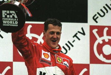 8 Oct 2000: Michael Schumacher of Germany and Ferrari celebrates with the trophy after winning the formula one world championship at the Japanese Grand Prix at Suzuka, Japan. Mandatory Credit: Mark Thompson/ALLSPORT