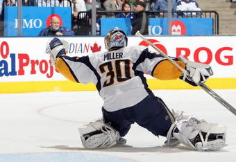 TORONTO - APRIL 8:  Goalie Ryan Miller #30 of the Buffalo Sabres blocks the puck against the Toronto Maple Leafs during their NHL game at the Air Canada Centre on April 8, 2009 in Toronto, Ontario. (Photo by: Dave Sandford/Getty Images)