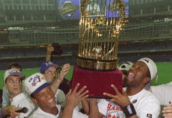 TORONTO - OCTOBER 23:  Outfielder Rickey Henderson and first baseman Joe Carter #29 of the Toronto Blue Jays hold up the World Series trophy after winning in Game Six against the Philadelphia Phillies at the Toronto Skydome in Toronto, Ontario, Canada. The Blue Jays won the game 8-6, winning the Series 4-2. (Photo by Rick Stewart/Getty Images)