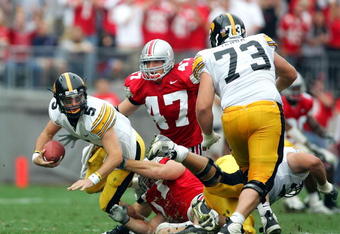 COLUMBUS, OH - SEPTEMBER 24:  Quarterback Drew Tate #5 of Iowa is sacked by Mike Kudla #57 of Ohio State as A.J. Hawak #47 of Ohio State and Marshal Yanda #73 of Iowa look on during the second quarter on September 24, 2005 at Ohio Stadium in Columbus, Ohio.  (Photo by Harry How/Getty Images)