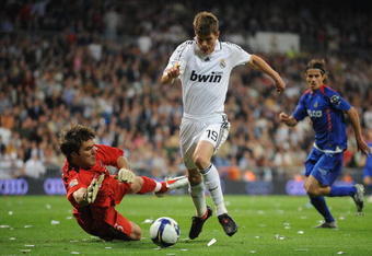 MADRID, SPAIN - APRIL 21: Klaas Jan Huntelaar of Real Madrid tries to get past  Vladimir Stojkovic of Getafe during the La Liga match between Real Madrid and Getafe at the Santiago Bernabeu stadium on April 21,  2009 in Madrid Spain.  (Photo by Denis Doyle/Getty Images)